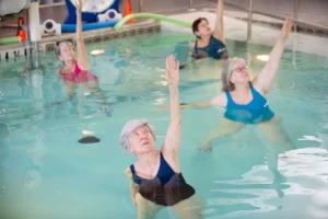 Four Becoming Center members do water aerobics in the heated pool.