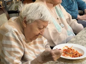 Artman resident looks at a bowl of spaghetti at Artman in Ambler, PA.