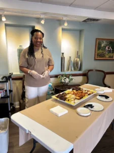 Woman stands near large serving of food