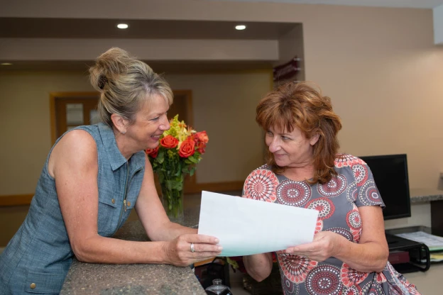 Two Artman team members look at a piece of paper