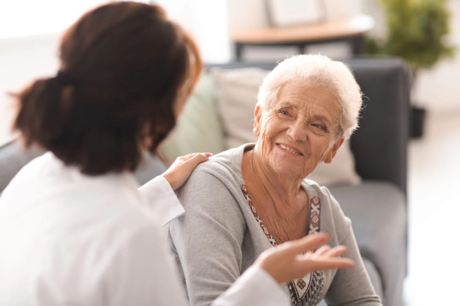 Young doctor visiting elderly woman